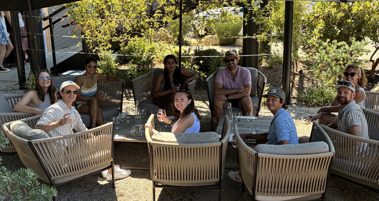 Friends relaxing together on a shaded winery patio during a Paso Robles wine tour